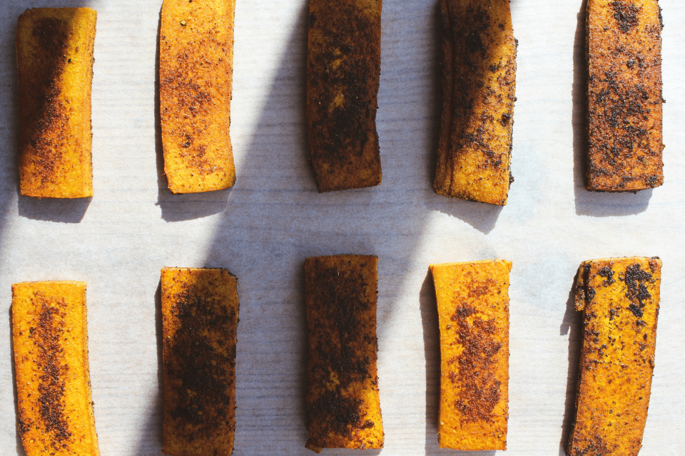 8 slices of golden tofu on a piece of parchment paper