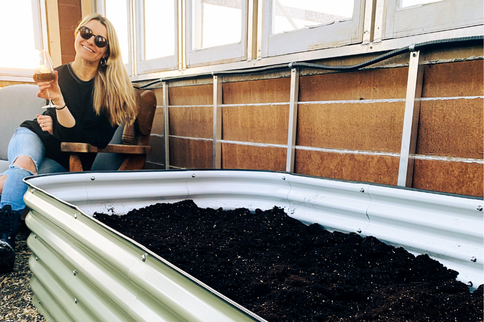 Maggie in greenhouse with Sproutbox raised bed